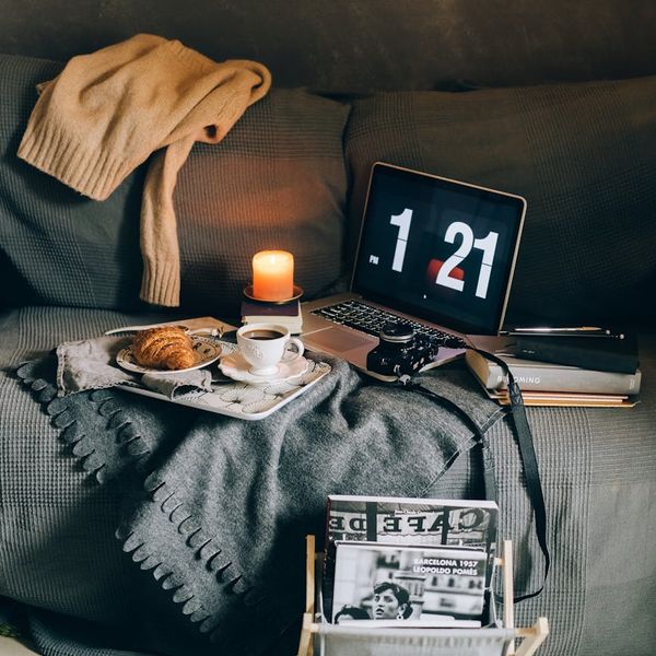 Cozy corner with a yoga mat, a candle, and a soft blanket.